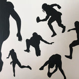 Installation of multiple football players on smooth wall.