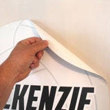 Peeling volleyball ball wall sticker from a smooth wall.