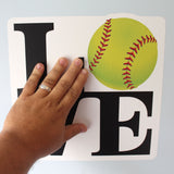 Applying Love Softball Wall Sticker to the wall.
