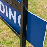 Up close picture of coroplast real estate pending sign slide into metal real estate frame.