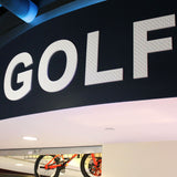 custom 3D Golf logo wall sign hung above interior storefront at Royal Pin, located in Indianapolis, Indiana